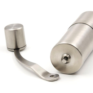 metallic silver hand coffee grinder on side
