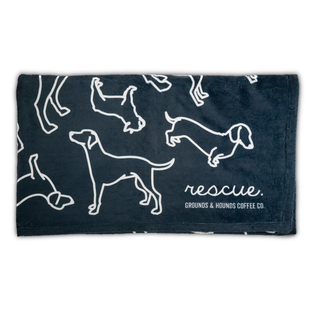 Navy blanket folded with dog outline design