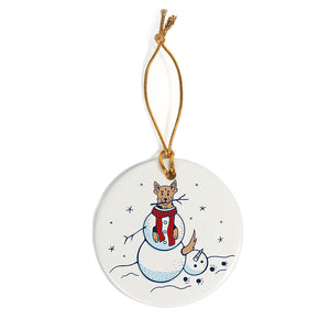 white ceramic round ornament of snowman with dog inside and red scarf